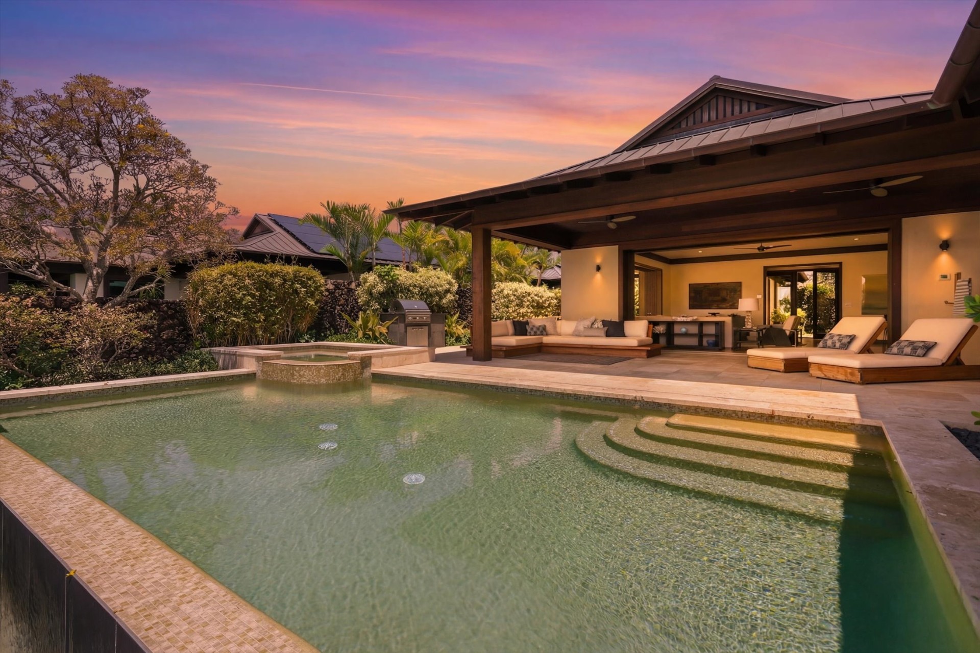 Pool and outdoor living pavilion at sunset